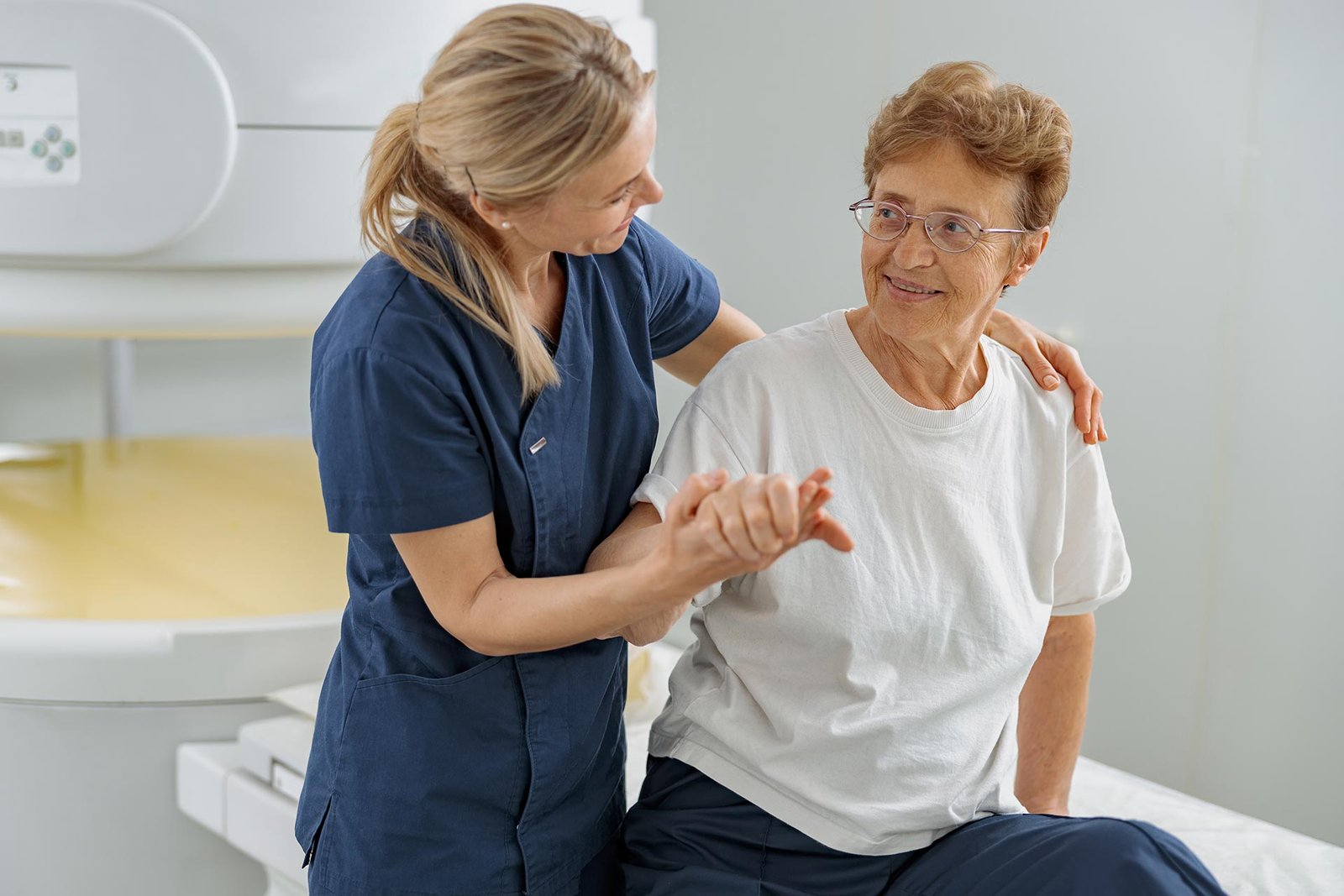 Nurse helping an older woman stand up safely