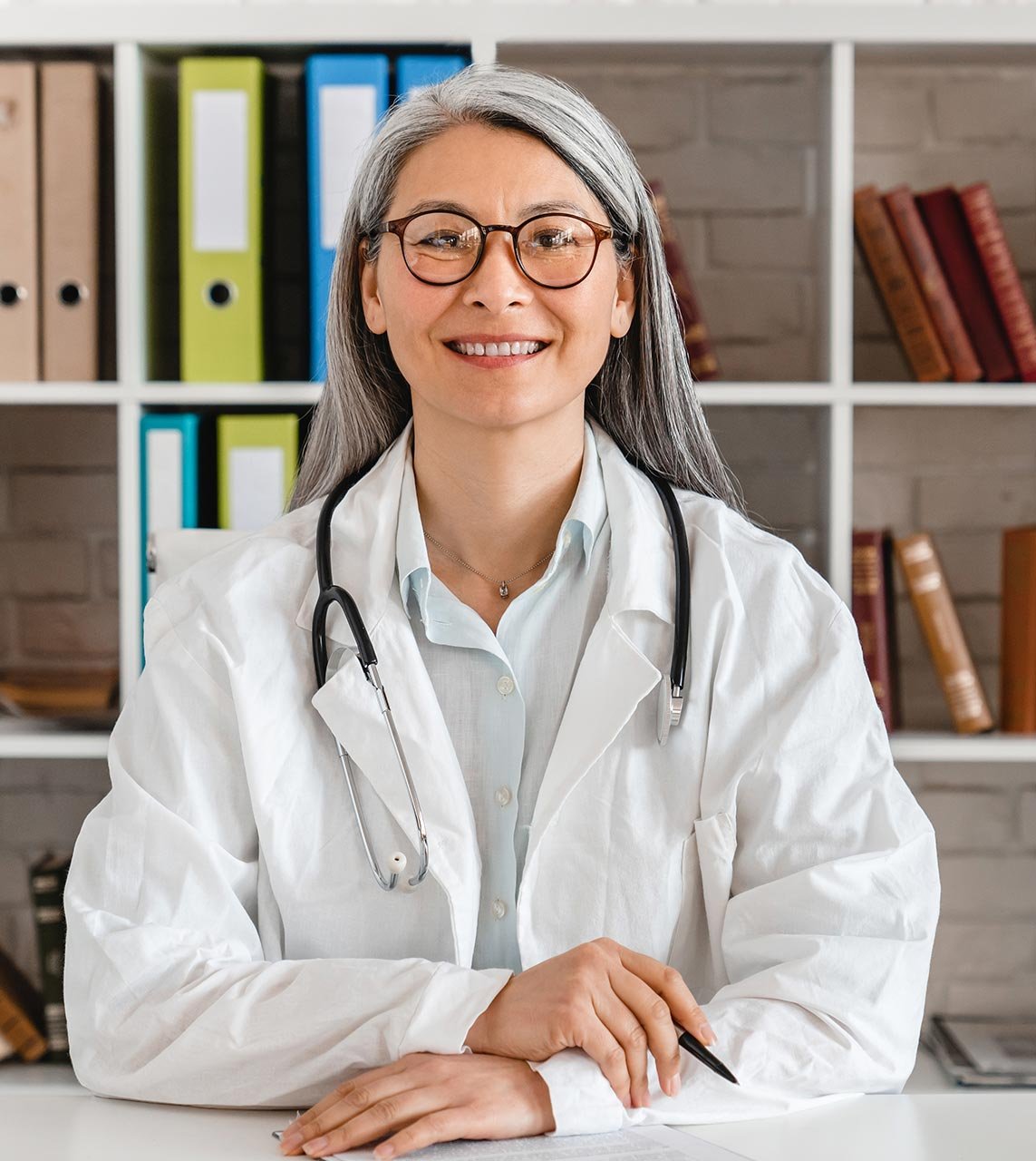 Doctor sitting at her desk in the consulting room