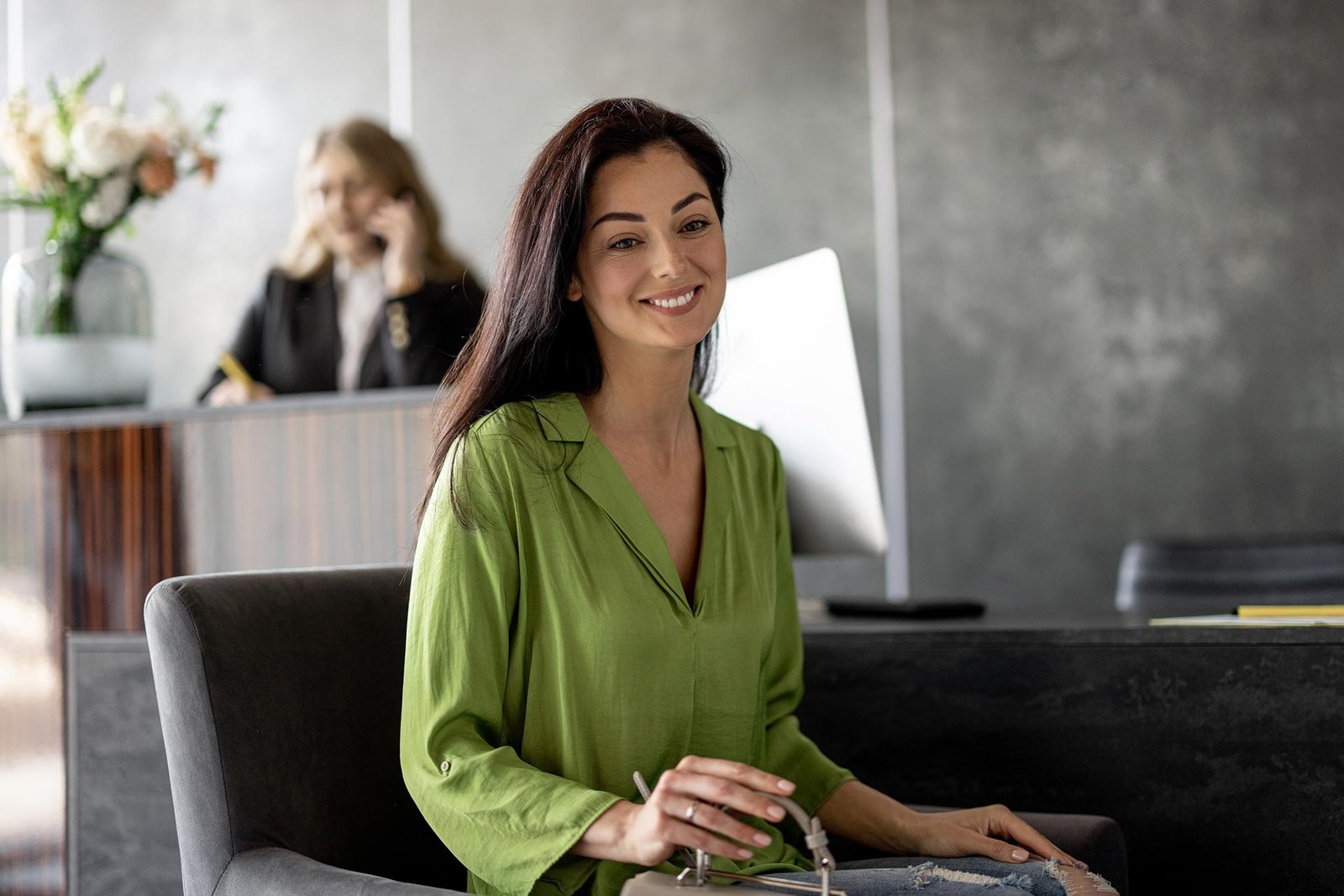 Woman being helped at a modern clinic reception desk